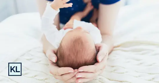 parent carrying baby